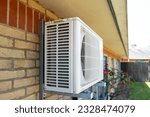 Small photo of Shallow focus of a large air con unit seen attached to the outside wall of an English hospital in mid summer.