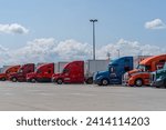 Small photo of Somerset, Pennsylvania – July 23, 2023: Semi-trucks parked in lot at rest stop on the Pennsylvania Turnpike.