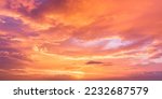 Small photo of Sunset Sky in the Evening with Orange, yellow sunlight on Golden hour sky, Dramatic storm Clouds background