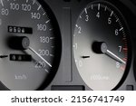 tachometer and speedometer in car dashboard at full power