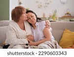 Small photo of beautiful moment between a mother and daughter, as they cherish their time together on the living room couch. Building Strong Family Bonds: The Key to Lifelong Connections