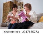 Small photo of Engaged in heartfelt chatter and the soothing rhythm of knitting. Art of Knitting: Knitting serves as a symbol of creativity, dexterity, and patience in this context.