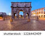 Small photo of Arch of Constantine - A dusk view of south side of Constantine's Arch, standing at between the Colosseum, right, and the Roman Forum, left. Rome, Italy.