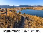 Small photo of Autumn Mountain Trail - An Autumn day view of a winding biking and hiking trail, overlooking Bear Creek Lake Park, at side of Mt. Carbon. Denver-Lakewood, Colorado, USA.