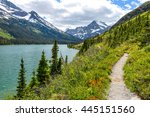 Spring Hiking Trail - A spring view of a hiking trail at shore of Lake Josephine, with Mount Gould and Allen Mountain rising at front and left, in Many Glacier of Glacier National Park, Montana, USA.