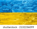 Wood texture background with cracks and knots in Ukraine colors flag.