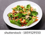 plate of stir fried vegetables on dark background