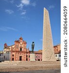 Small photo of Lugo, Ravenna, Emilia Romagna, Italy - August 19, 2021: the statue of the Italian top fighter ace of World War I Francesco Baracca with the 27m high airplane wing and the ancient Suffragio church