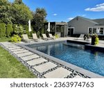 Small photo of Stunning luxury backyard view of pool, chaise lounges, garden, pergola with hot tub. Modern and sleek, it has an effortless boho inspired, resort like feel. Inspired by Tulum, Mexico's eco-chic feel.