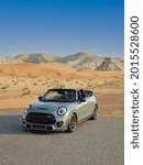 Small photo of UAE, DUBAI - 07-20-2021: Mini Cooper , Car in desert gray color brand new car, sporty soft top convertible