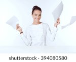 Small photo of the business woman sits at a white table and holds the handle ilist of paper