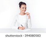 Small photo of the business woman sits at a white table and holds the handle ilist of paper