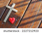 Small photo of Red heart, wooden Jesus cross on plank. Concept Jesus loves you, Jesus crucify himself with love. Forgiving sin, Easter time , Faith God. Christianity background, copy space.
