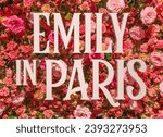 Small photo of tokyo, japan - may 31 2023: Art installation depicting the title of the American romantic comedy-drama television series Emily in Paris made in polystyrene in front of a pink roses floral background.