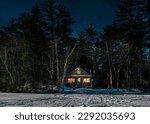 Log cabin on moonlit winter night
