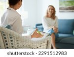 Counseling or therapy session with psychologist or doctor and client in office or practice room