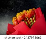 A bouquet of red tulips on a...