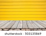Background with wooden deck tabletop and wooden yellow wall