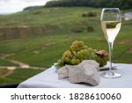 Small photo of White chalk stones from Cote des Blancs near Epernay, region Champagne, France, glass of blanc de blancs champagne from grand cru vineyards in Cramant and white chardonnay grapes close up