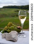 Small photo of White chalk stones from Cote des Blancs near Epernay, region Champagne, France, glass of blanc de blancs champagne from grand cru vineyards in Cramant and white chardonnay grapes close up