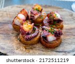 Small photo of Spanish starter dish in fish restaurant in Getaria, grilled octopus with roasted potatoes and paprika, Basque Country, Spain