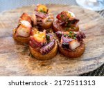 Spanish starter dish in fish restaurant in Getaria, grilled octopus with roasted potatoes and paprika, Basque Country, Spain