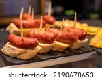 Typical snack in bars of Basque Country pinchos or pinxtos, small slices of bread upon which ingredient or mixture of ingredients is placed and fastened with toothpick, San Sebastian, Spain, close up