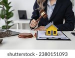 Small photo of Property Auction Woman's hand holding hammer and model house, real estate lawyer in house sale, finance and foreclosure, ownership concept.