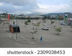Small photo of Lowveld Mall, Hazyview – 04.12.2023: African men loiter in an almost empty car park