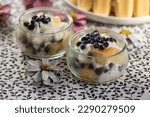 Delicious summer dessert with whipped and sour cream covered with baked sponges, tasty cold cake for hot summer season with cone flowers decoration