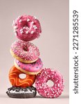 Small photo of Creative composition of various donuts. Set of donuts with different color glaze. Donuts with chocolate, erysipelas icing, marshmallows and various flavorings.