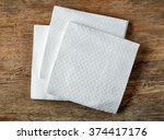 White paper napkin on wooden table, top view
