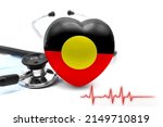 Small photo of Flag of Australian Aboriginal in the form of a heart next to a stethoscope, the concept of the world health system