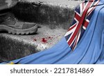 Small photo of The leg of the military stands on the step next to the flag of Tuvalu, the concept of military conflict