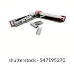 Pink stapler and piles of copper office staples on white background, closeup, top view