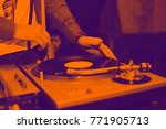 Dj mix tracks at party on vinyl record player. The Duotone effect - orange and purple