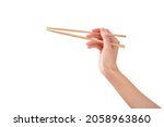 female hand holds Wooden chopsticks isolated on white background.