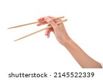 female hand holds Wooden chopsticks isolated on white background.