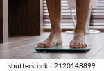 Small photo of Close-up male legs slender thin sporty unrecognizable guy male athlete standing at home bathroom walking barefoot on electronic scales checking weight slimming body control kilograms sports fattening