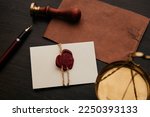 Notary stamp, scale and envelope with wax seal on a wooden table. Notary tools.