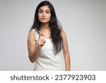 Small photo of Indian scold women showing finger point expression to front of the camera with different moods or facial expressions. Concept of scold, feelings, facial expression on isolated white background.