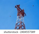 Small photo of High voltage power lines tower on green mountain, Red high Pylon high-voltage power lines, high voltage electric transmission tower for producing electricity at high voltage electricity poles
