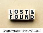 Letter block in word lost & found on wood background