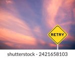 Small photo of Yellow transportation sign with word retry on violet color sky background