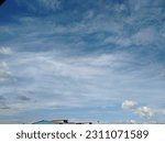 Small photo of Blue sky illuminated by the sun, a set of beautiful white and grayish clouds that form figures in the firmament with the movement of the wind above the city in the middle of the calm morning