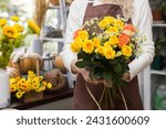 Florist holding a bouquet in a...