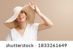 Small photo of Portrait of beautiful young asian woman wearing straw hat wide brim to protect her flawless face from ultraviolet in the sunlight. Facial Sunscreens, SPF, Sunspots, Treatments, Skin care products.