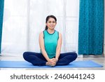 Yoga lover smiling while doing...