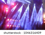 Performance moving lighting on construction light beam ray downward in yellow blue color, on Concert and Fashion Show stage ramp with smoke