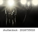 Concept every Girls Dream to be Miss beauty pageant queen Universe contest. Women warships raise Diamond Silver Crown as Final winner on stage, studio lighting with backlit light flare silhouette